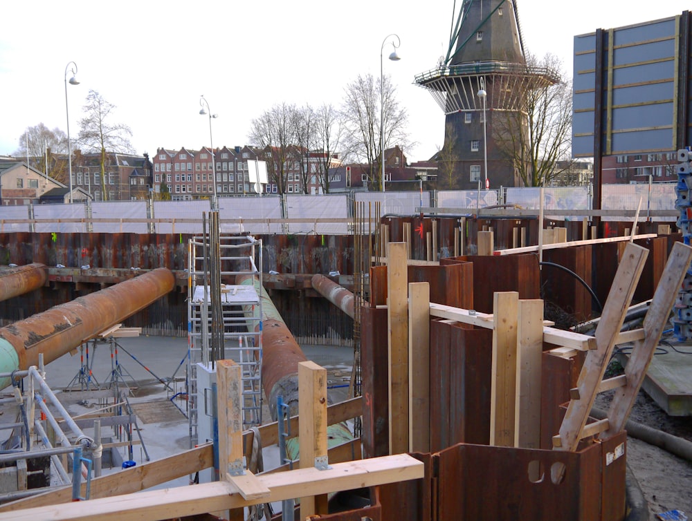 a construction site with a clock tower in the background