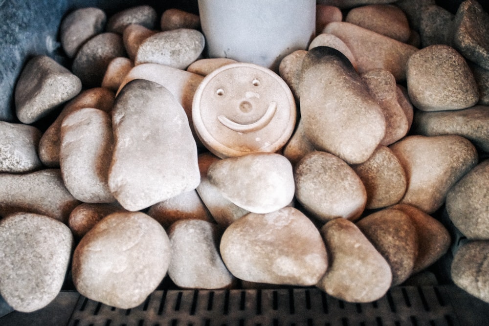 a cup sitting on top of a pile of rocks