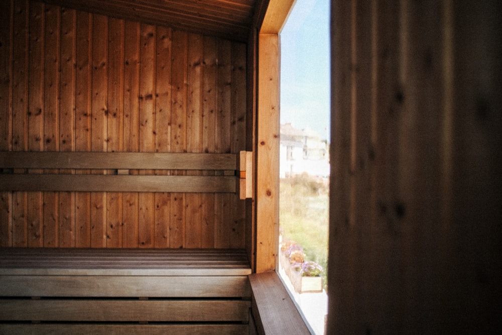 a sauna with wooden walls and a window