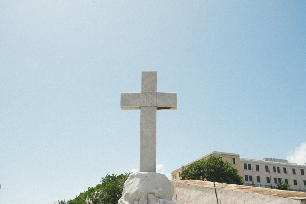 a large white cross on top of a hill