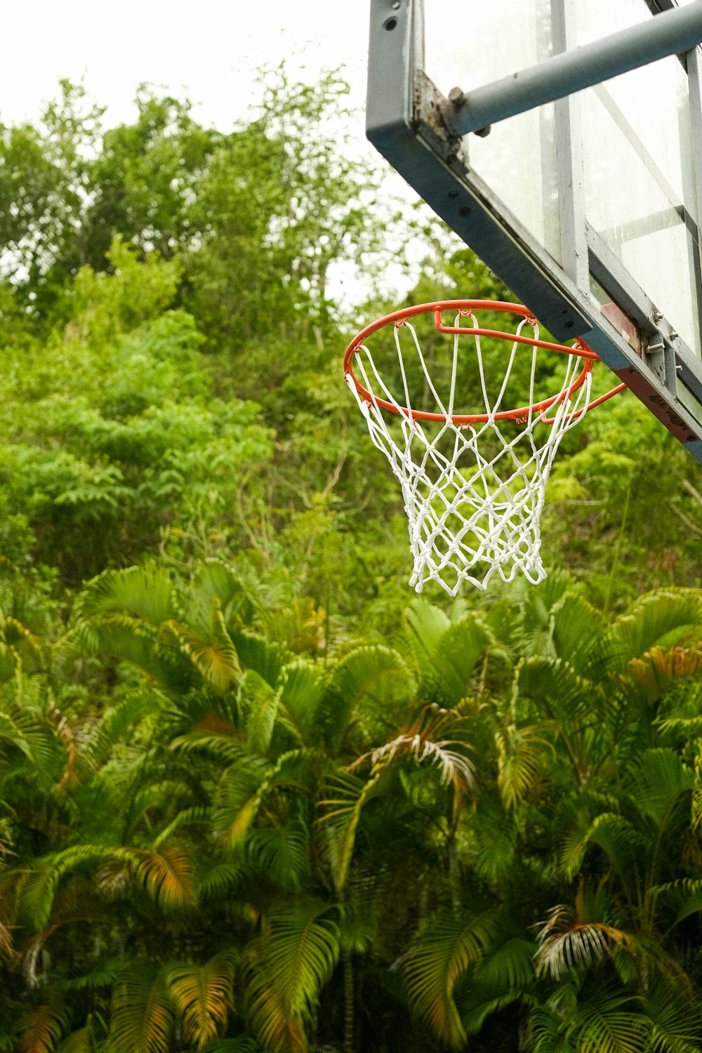 a basketball going through the net of a basketball court