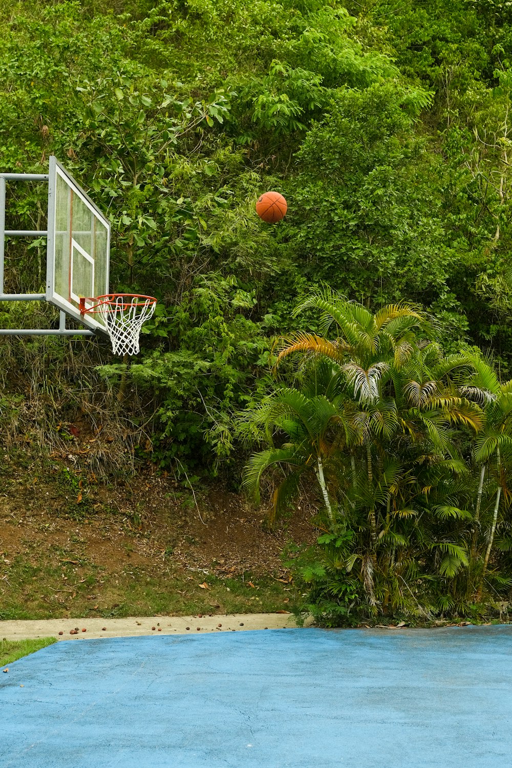 a basketball court with a basketball in the air