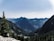 A satisfied traveler exploring a scenic mountain landscape.