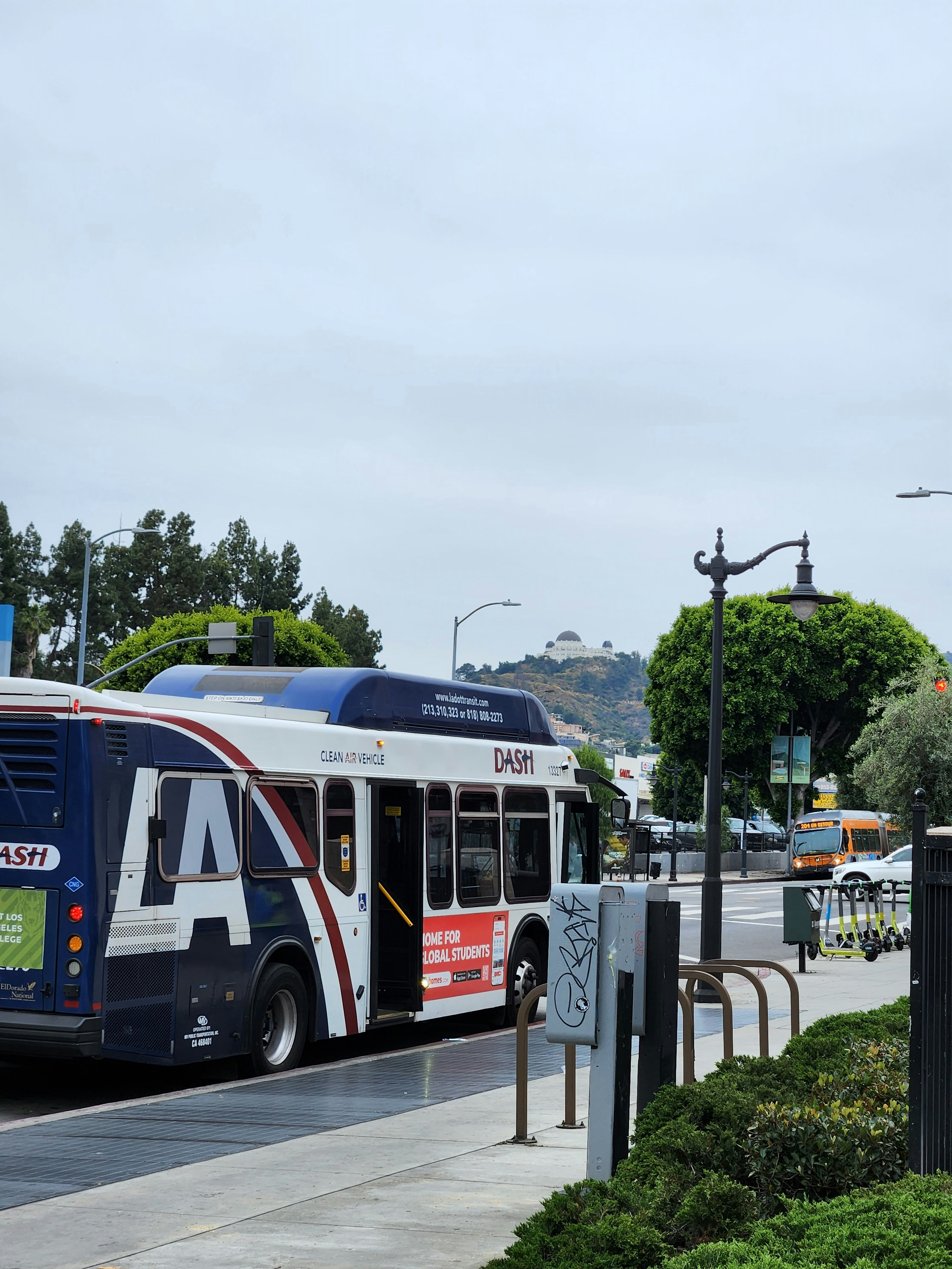 a blue and white bus driving down a street