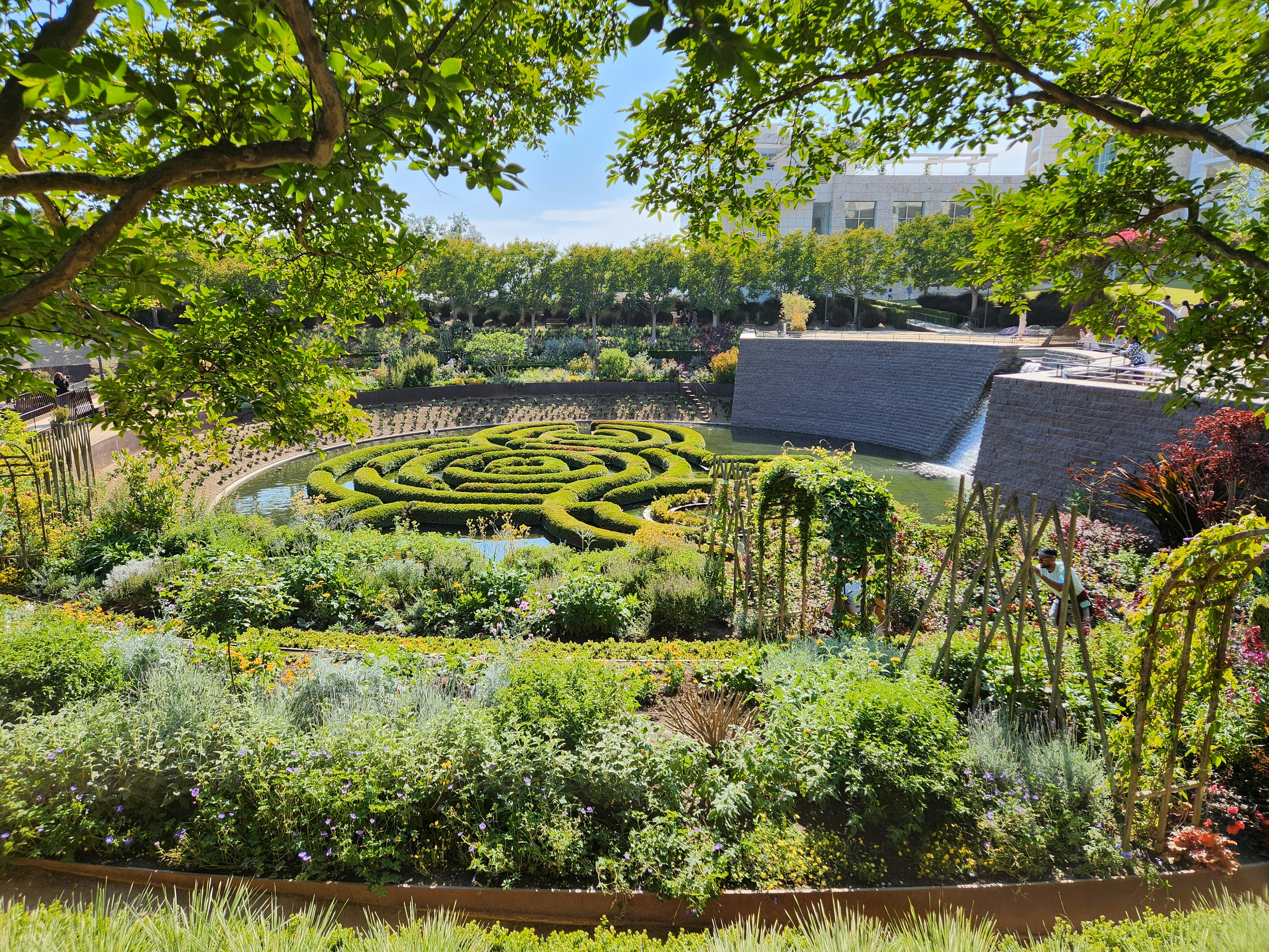 a garden with a circular maze in the middle of it
