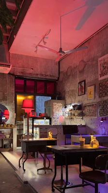 Warmly lit cafe interior with jharkhandi-inspired wall art and wooden furniture.