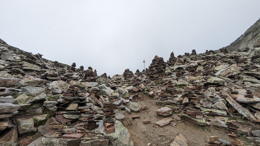 a rocky mountain with a cross on top of it