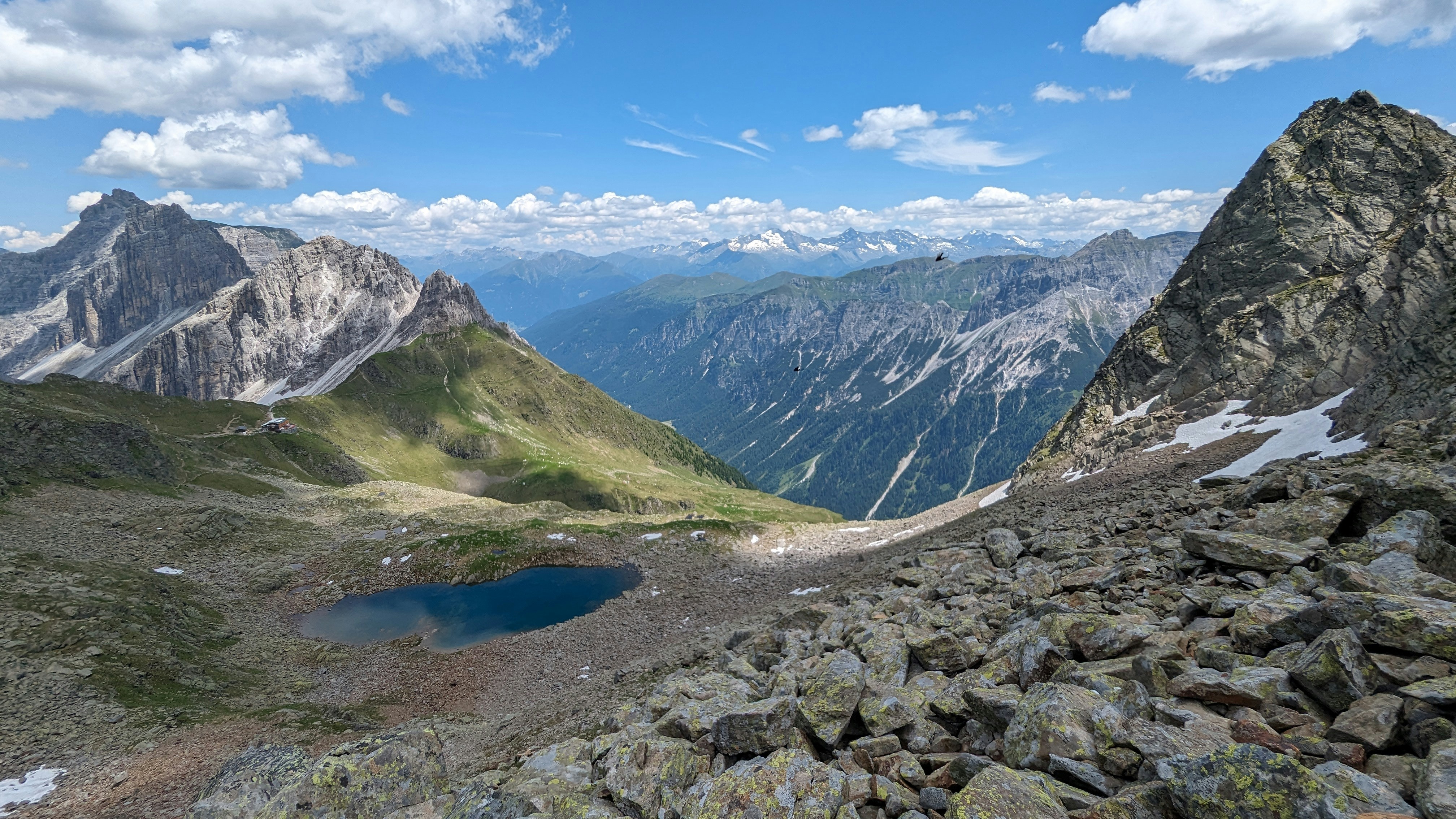 A view of a mountain range with a lake in the foreground