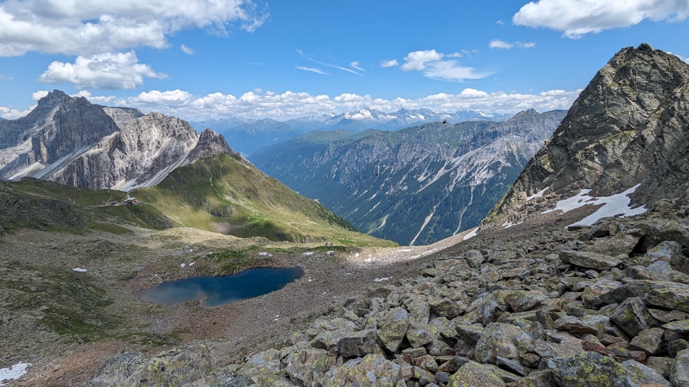 a view of a mountain range with a lake in the foreground