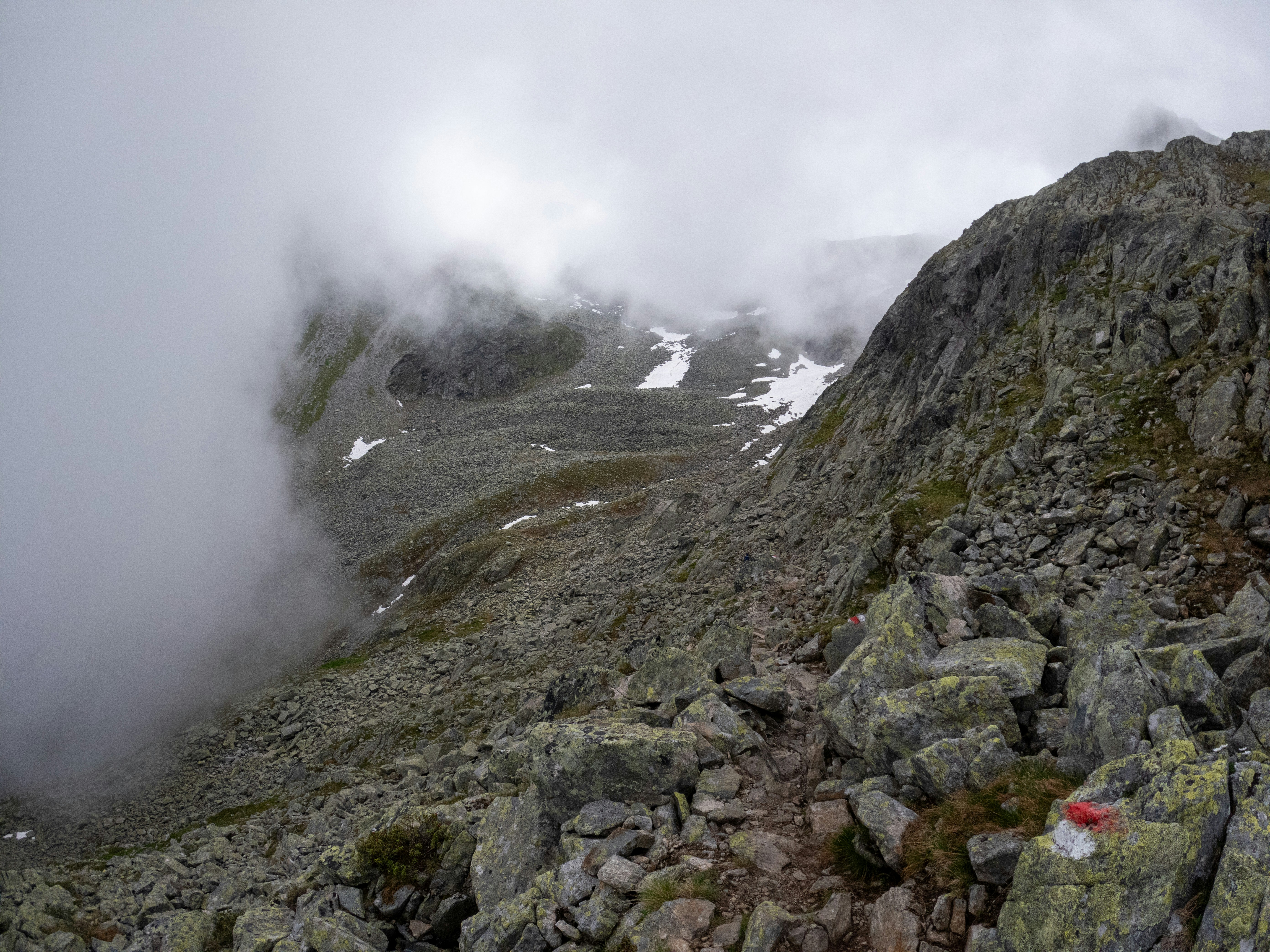 A rocky mountain with low-lying rocks and clouds