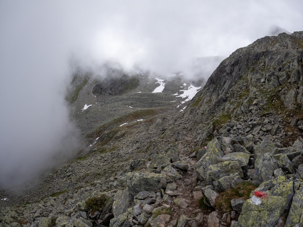 a rocky mountain with low lying rocks and low lying clouds