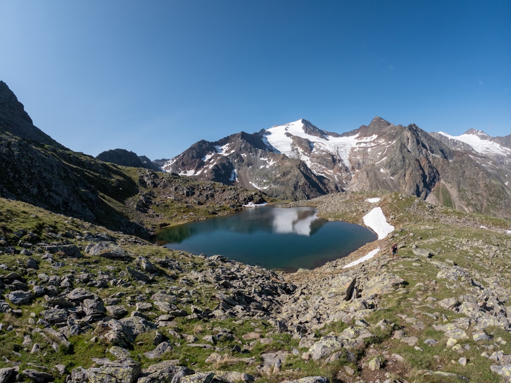 a small lake in the middle of a mountain range