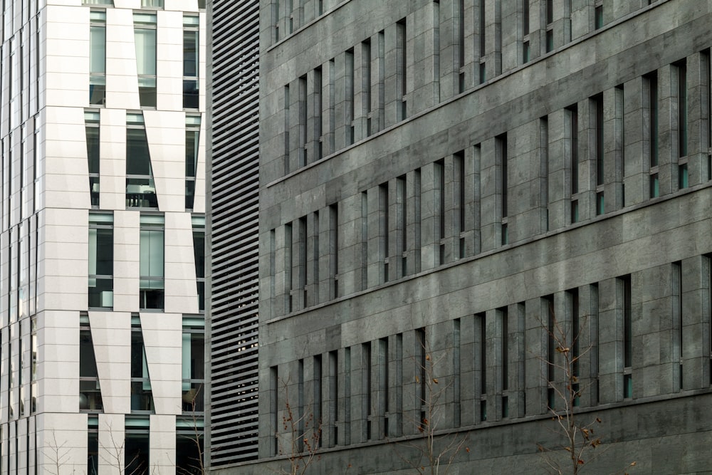 a tall building with many windows next to another building