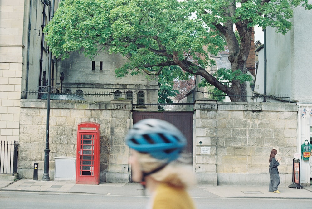 a man riding a bike down a street next to a tall building