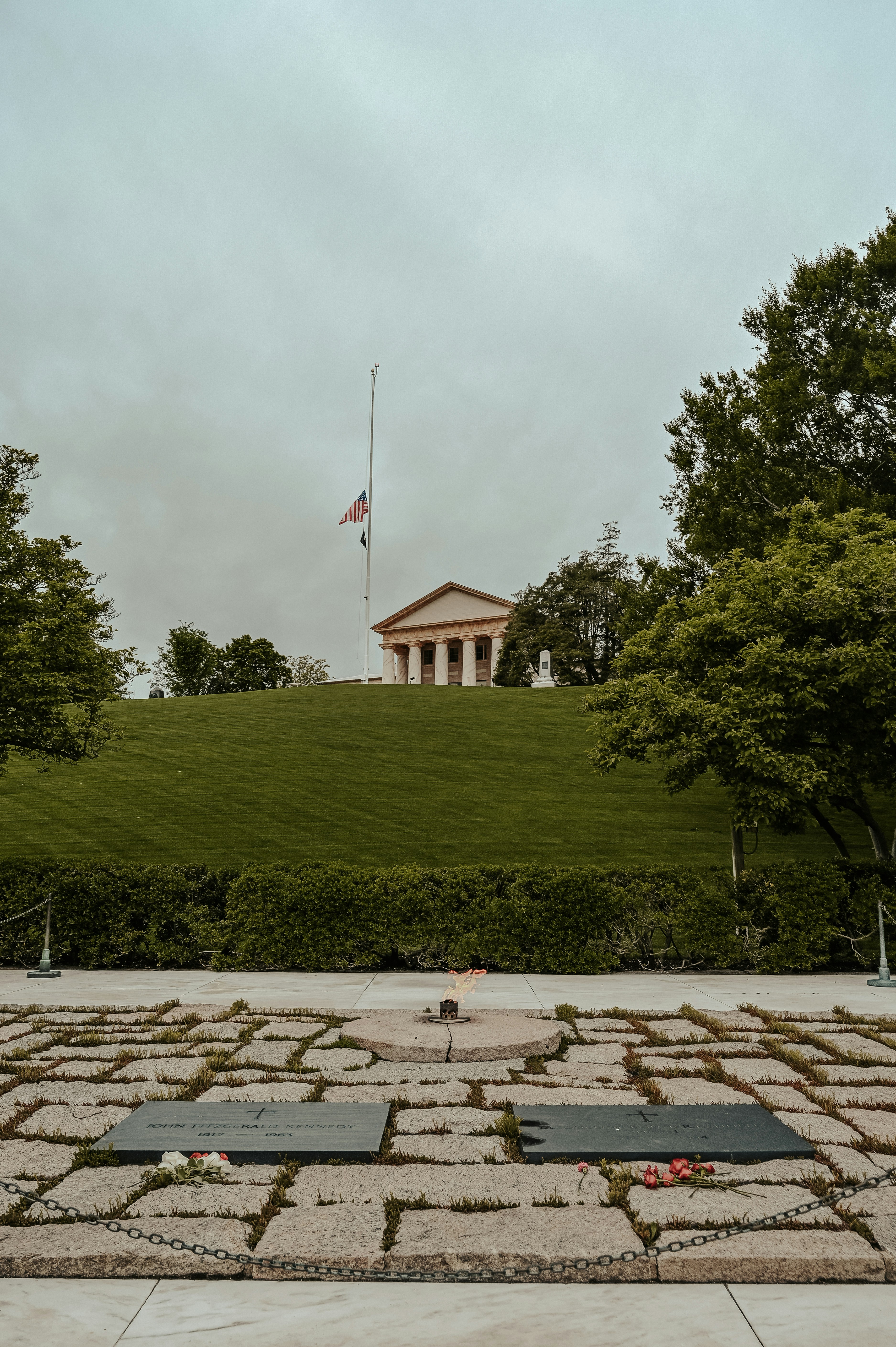 a grassy hill with a flag on top of it