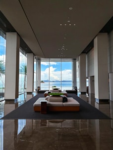 Elegant modern apartment lobby with ocean blue and gold accents, reflecting luxury hospitality.