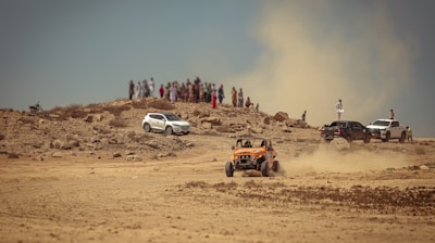 a group of people standing on top of a dirt hill