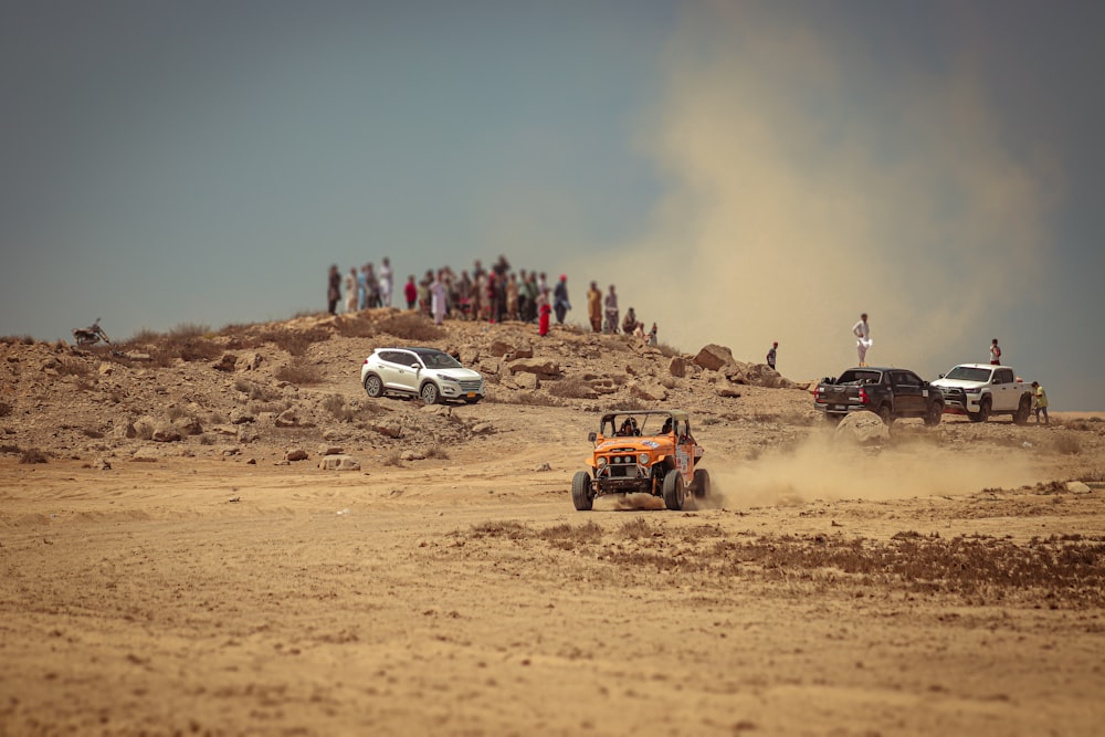 a group of people standing on top of a dirt hill