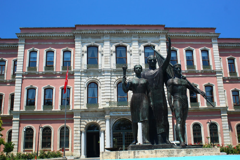 a statue of a man and a woman in front of a building