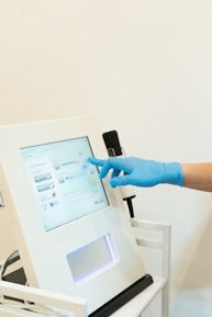 Close-up of hands using advanced medical equipment with blue accents.