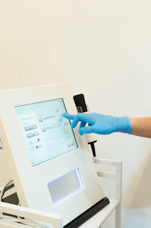 a person in blue gloves is operating a machine