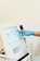 a person in blue gloves is operating a machine