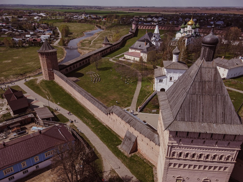 an aerial view of a castle with a river running through it