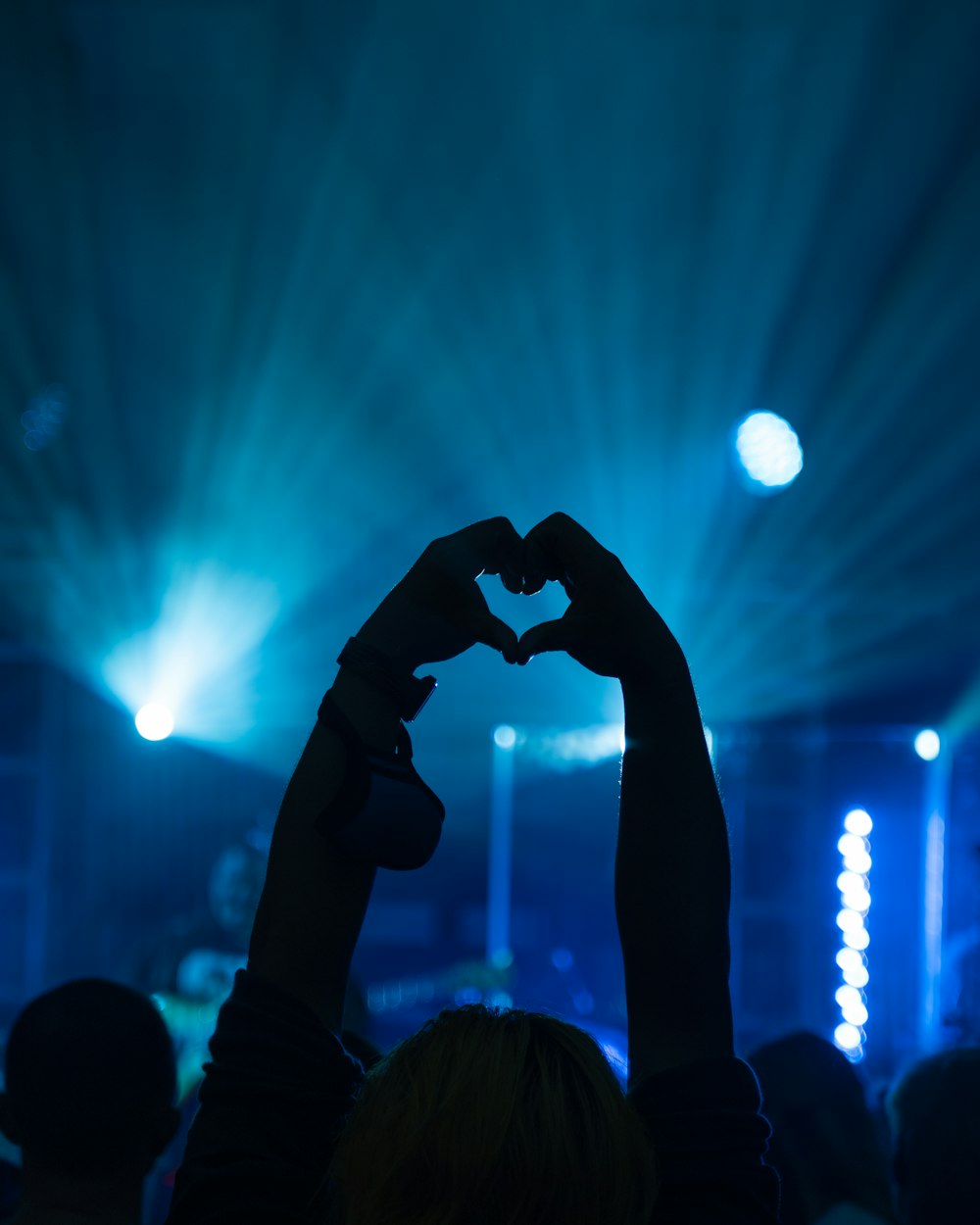 a person making a heart shape with their hands