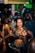 A vibrant event scene with guests enjoying a photobooth, capturing joyful moments and laughter.