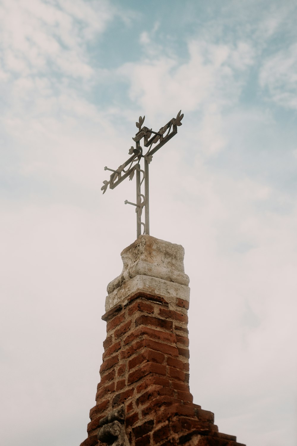 a weather vane on top of a brick building