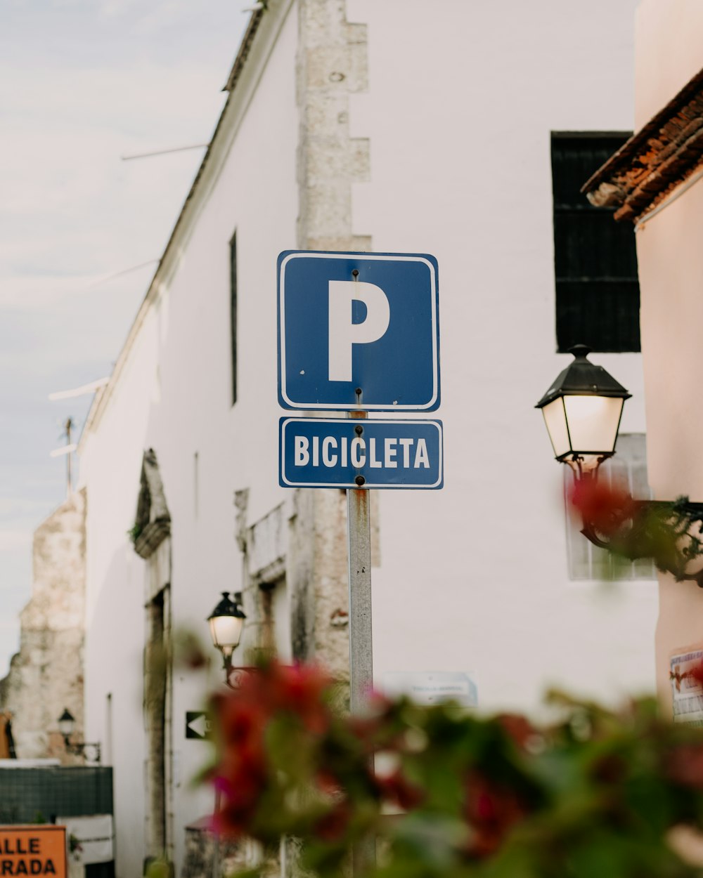 a blue street sign sitting on the side of a building