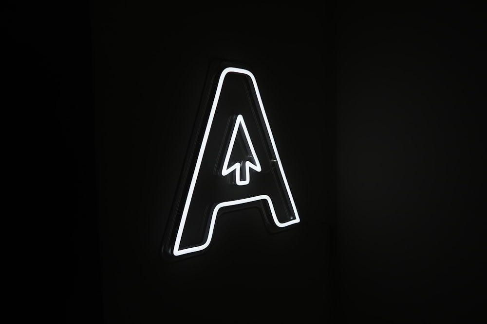 a neon sign with an arrow on it