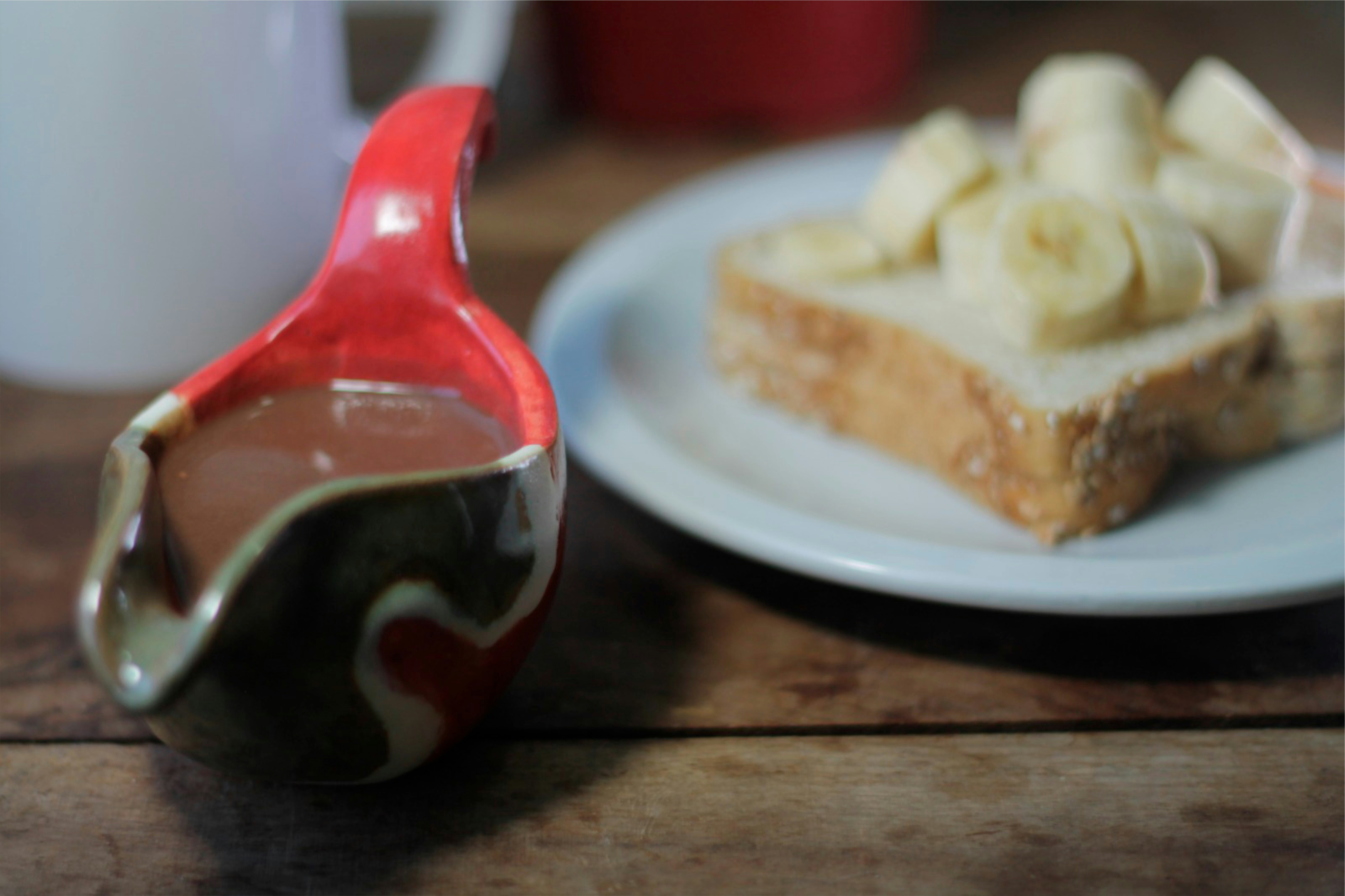 a piece of cake on a plate next to a cup of coffee