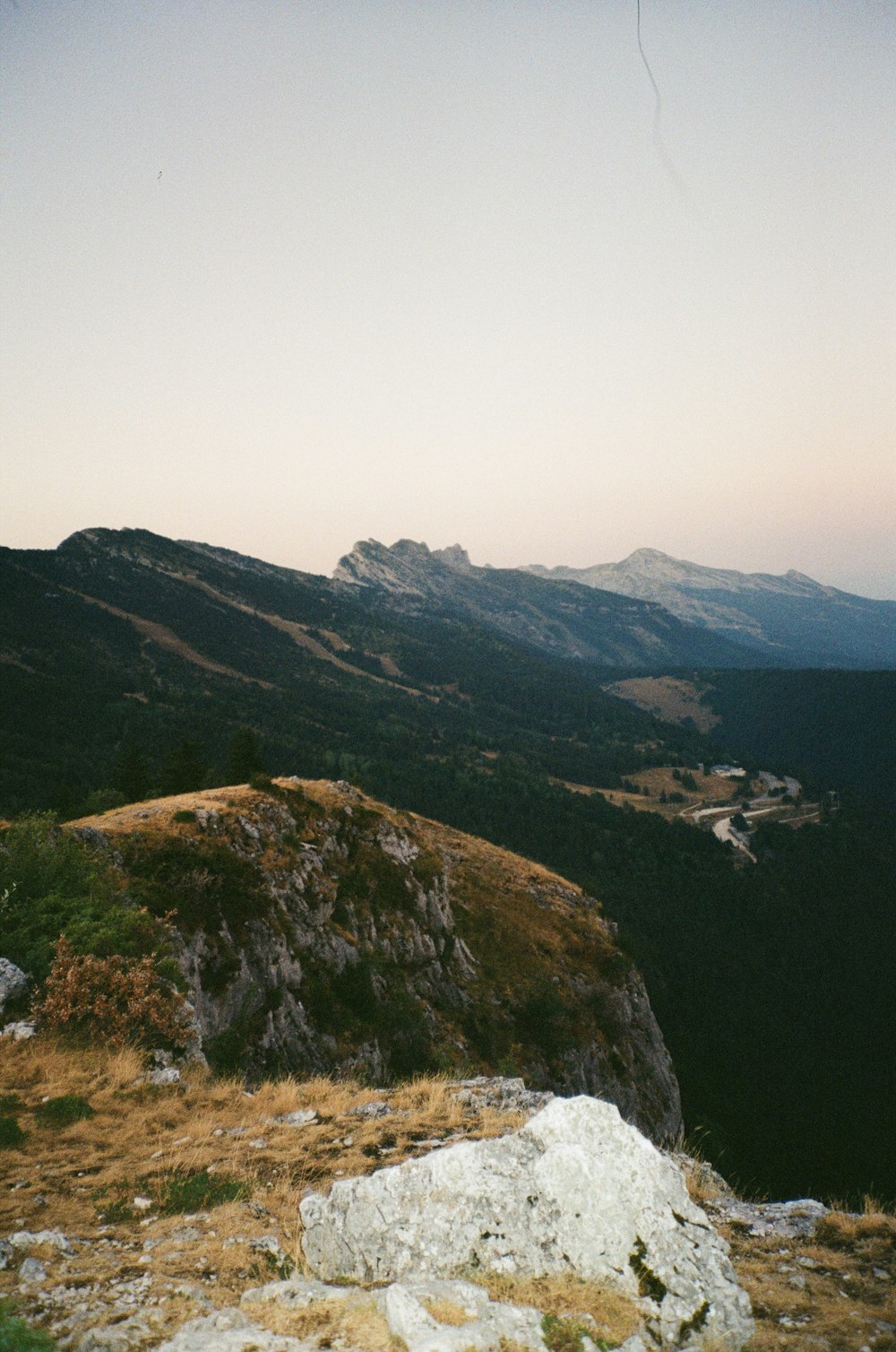 a view of a mountain range from the top of a hill