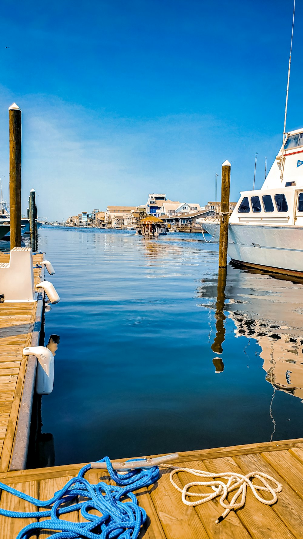 a boat docked at a dock with a rope