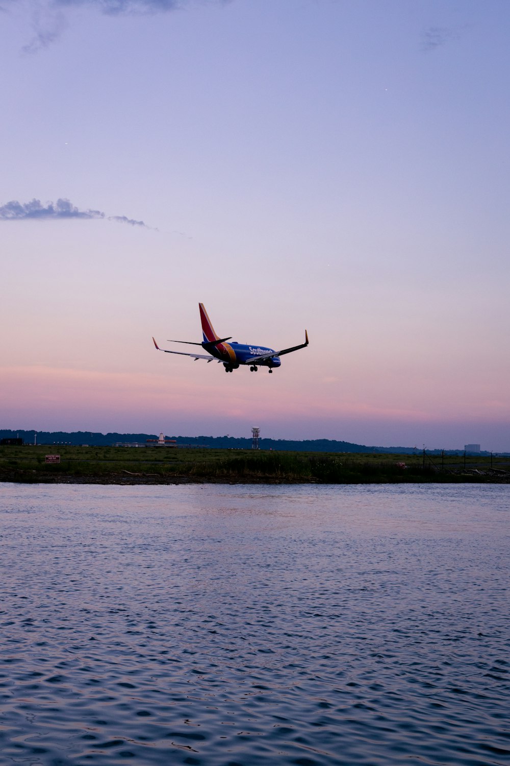 an airplane flying low over a body of water