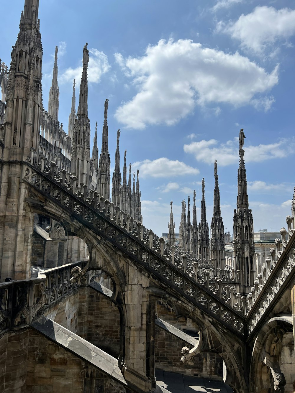 a view of the roof of a building with many spires