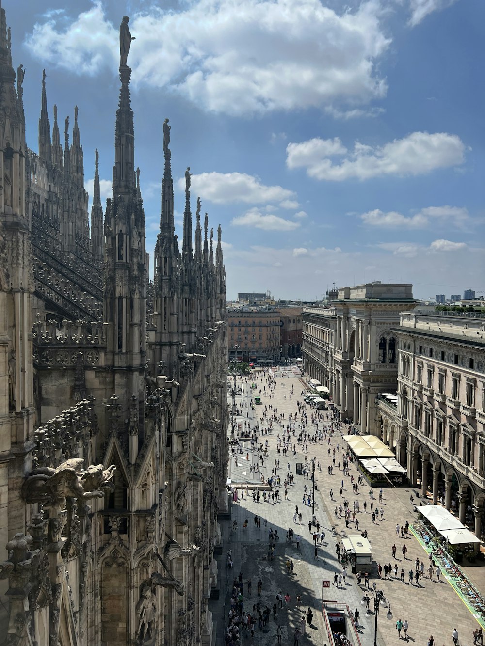 a view of a large cathedral with many people walking around it