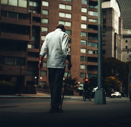 An individual confidently navigating a local neighborhood with a support worker nearby.
