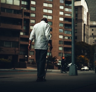 A visually impaired person using a smart cane with sensors.