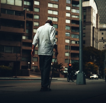 A visually impaired person using a smart cane with proximity sensors.