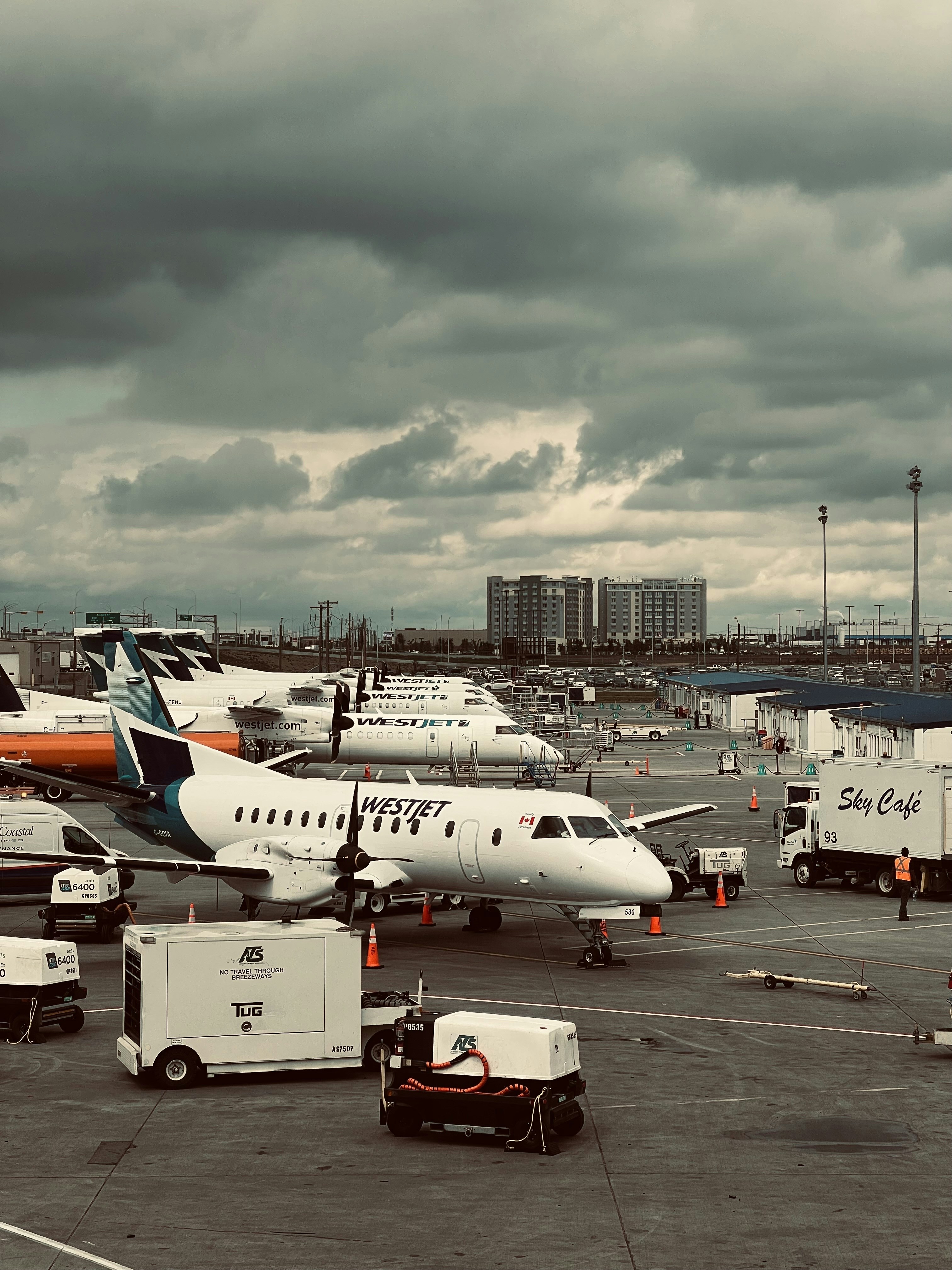 A group of airplanes sitting on top of an airport tarmac photo – Free ...