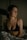 a woman in a bra top sitting on a bed