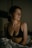 a woman in a bra top sitting on a bed