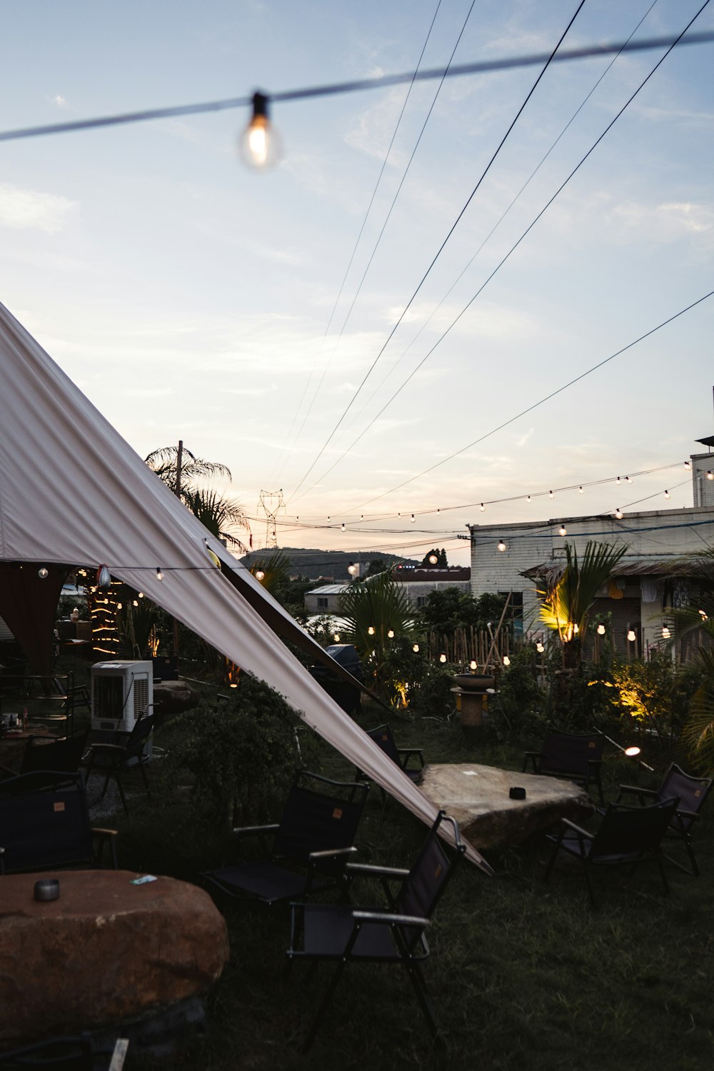 a white tent sitting on top of a lush green field