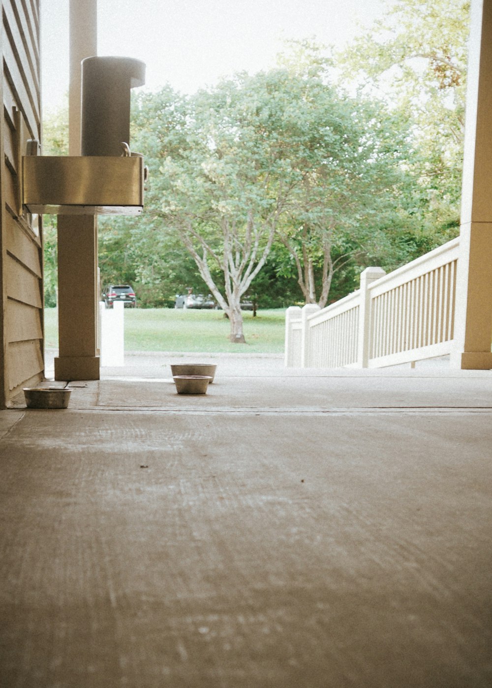 a bowl is sitting on the porch of a house