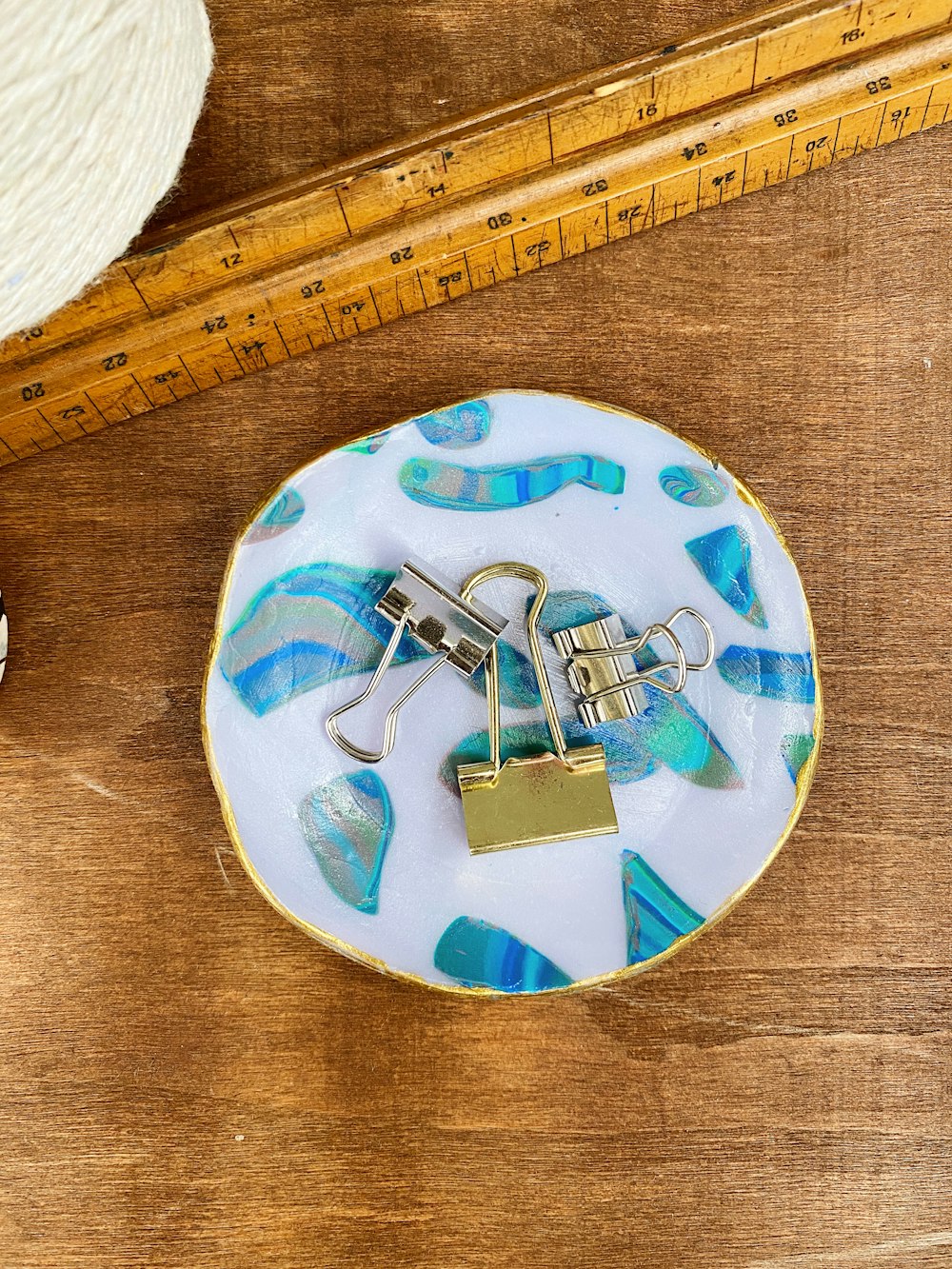 a white and blue plate sitting on top of a wooden table