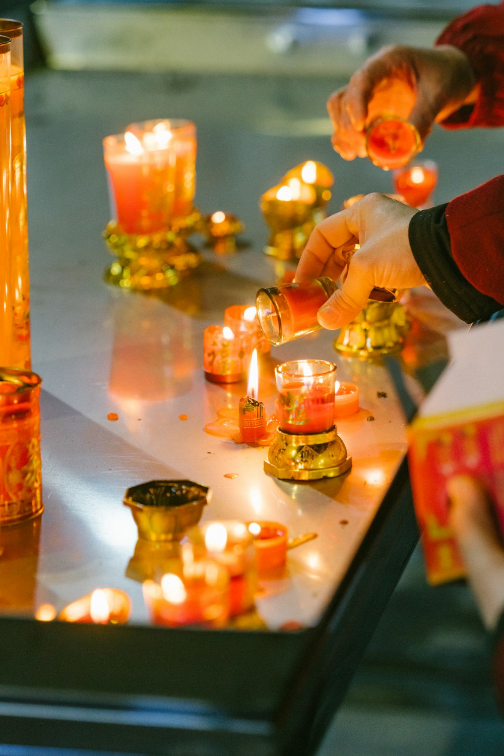 a group of people lighting candles on a table