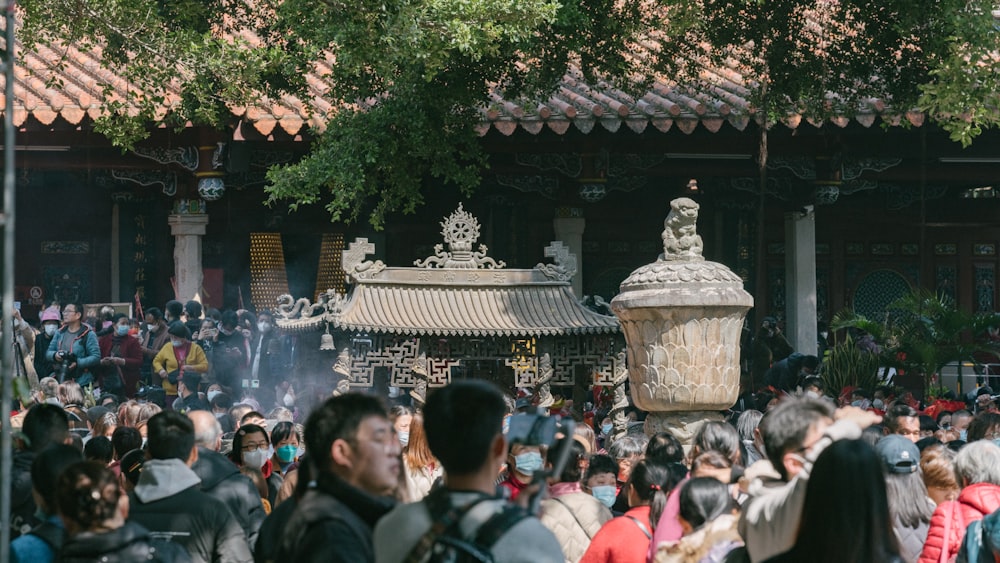 a crowd of people standing around a building