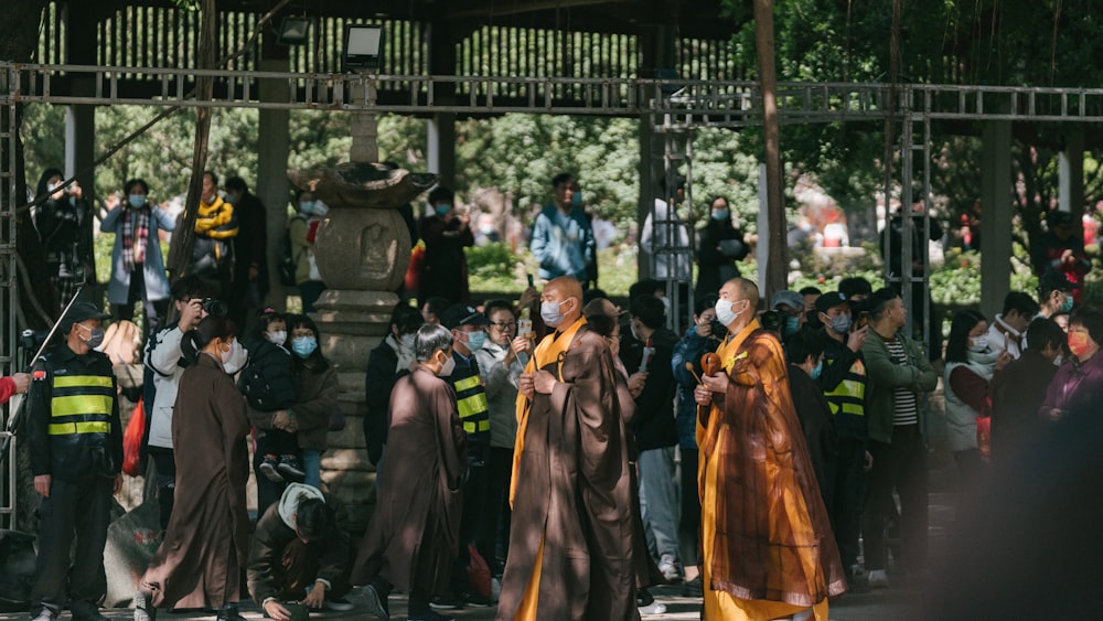 a group of people standing around each other